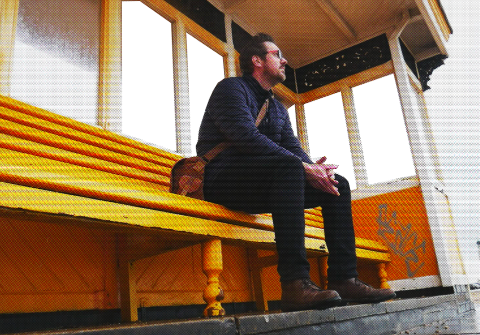 A photo of Rob Lambert sat on a bench